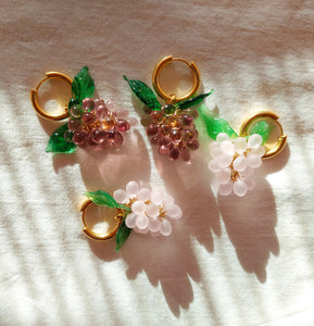 Gold plated hoop earrings with a handmade glass grape charm. The perfect gift for women who love colorful jewelry.