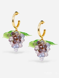 Grape earrings made of gold hoops and glasss beads.