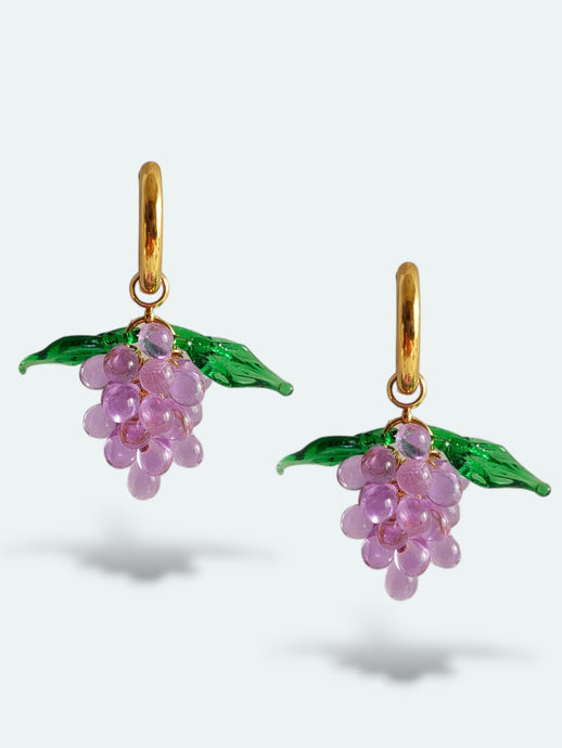 Handmade gold hoop earrings with grape charm made of lilac glass drops.