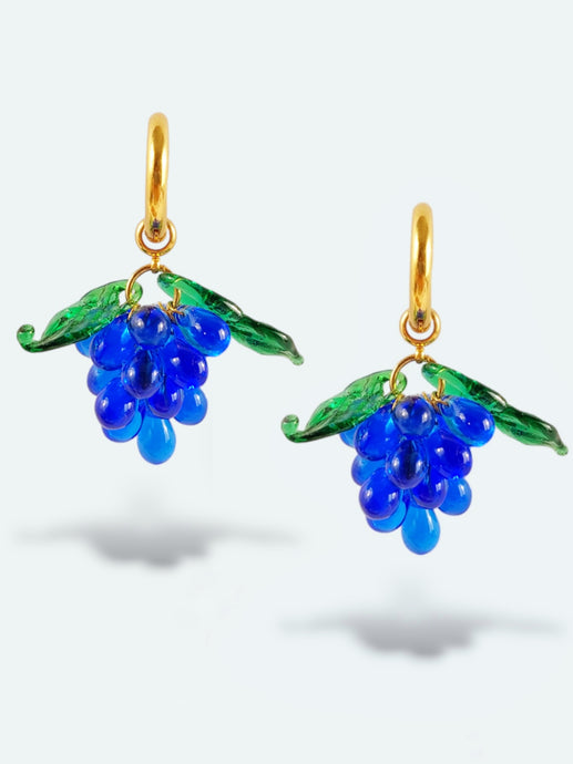 Handmade gold hoop earrings with grape charm made of blue glass drops.