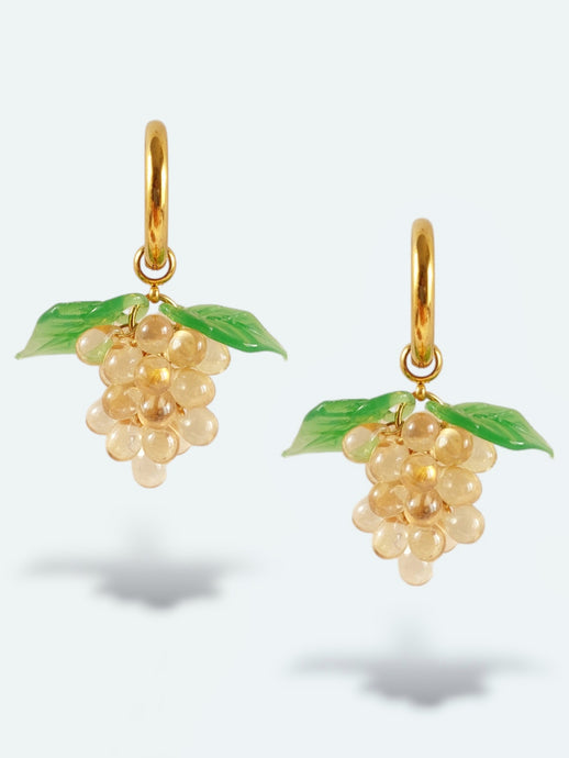 Handmade gold hoop earrings with grape charm made of beige glass drops.