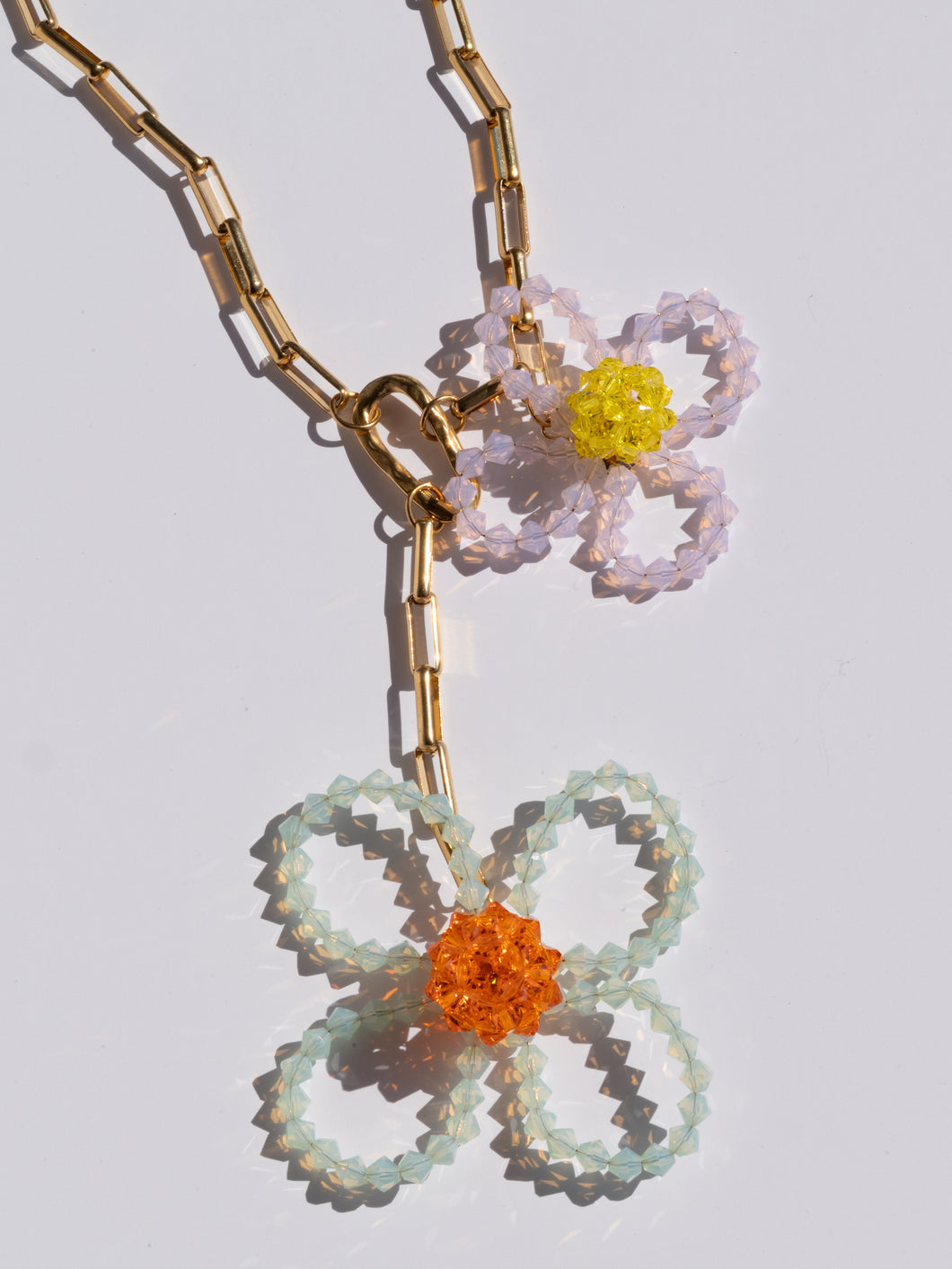 Handmade chunky necklace with colorful glass-bead flowers and a chunky gold-plated chain.